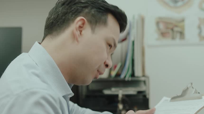 A doctor is talking and taking notes