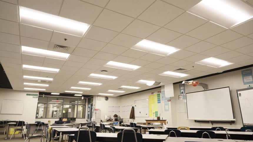 Bright classroom with chairs tables and blackboard