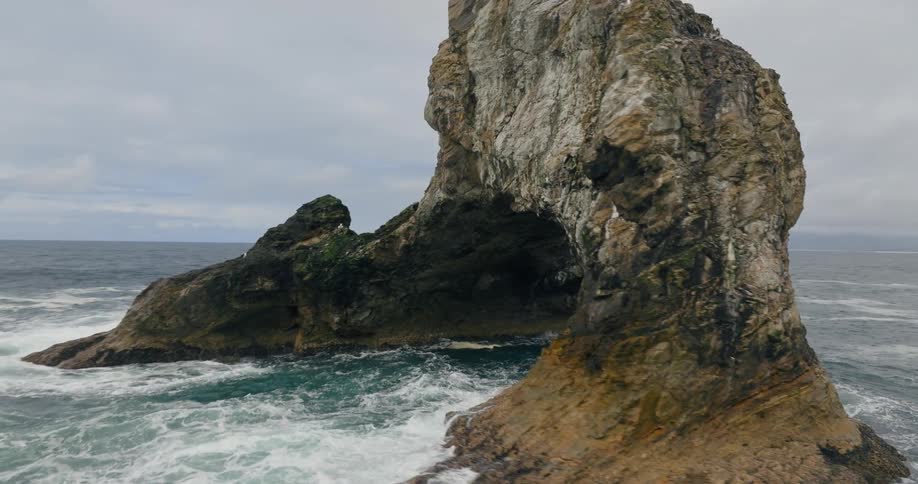 Aerial view of a natural rock arch in the ocean