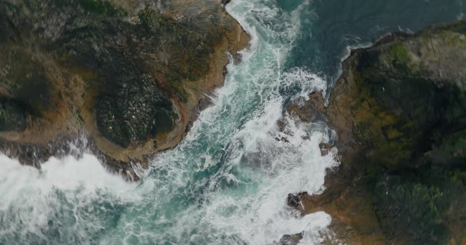 Waves crash against rocky coastlines