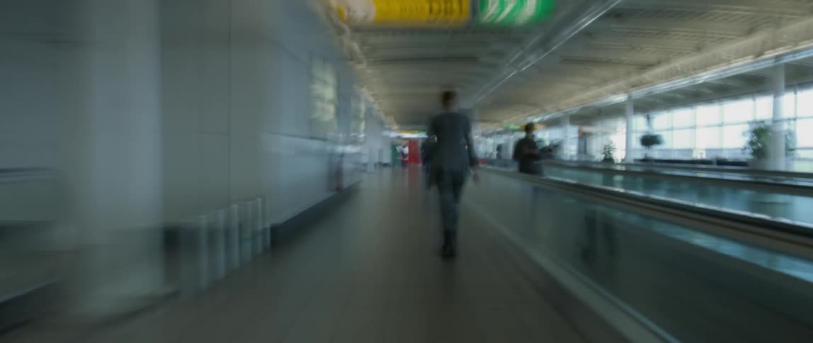 People walking in an airport corridor