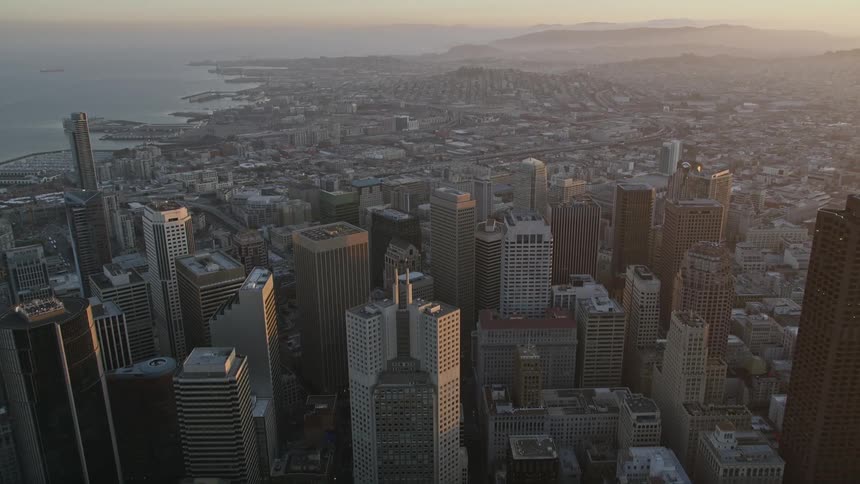 Aerial panorama of an urban city with skyscrapers and seaside on a morning