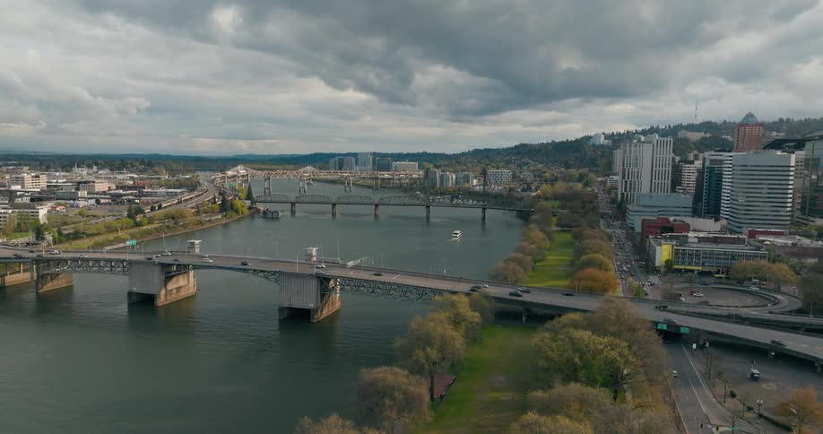 Aerial scenery of bridges over a maritime canal in a metropolis on a cloudy day