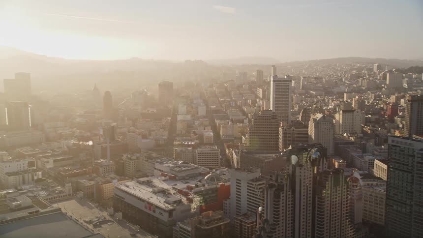 Aerial panorama of a metropolis with skyscrapers and large buildings with morning solar reflections