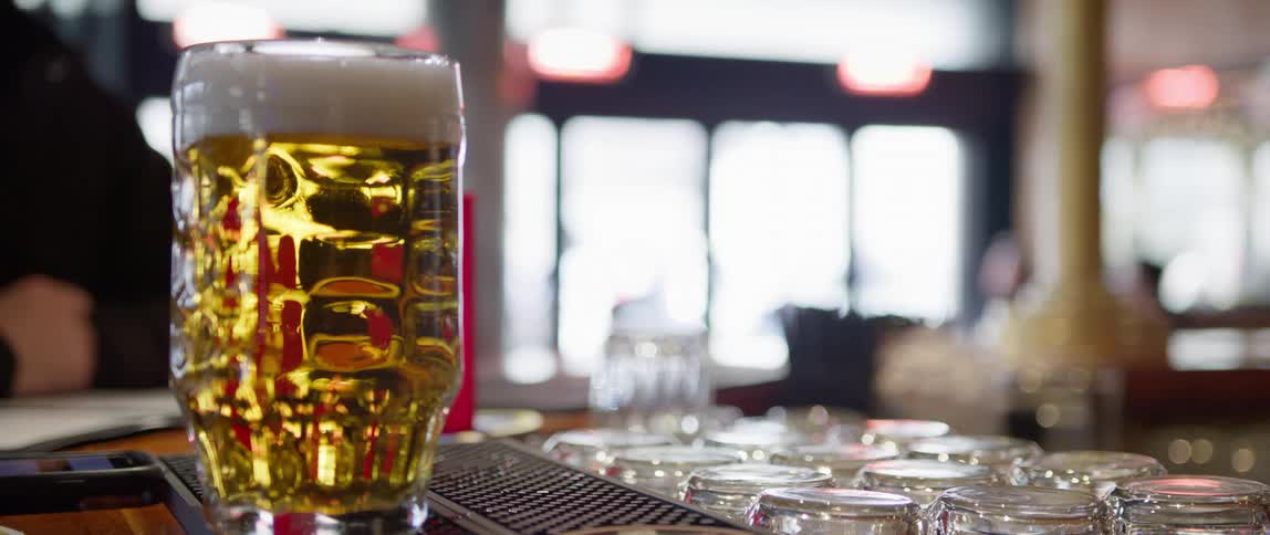 Glass of beer on a counter in a bar