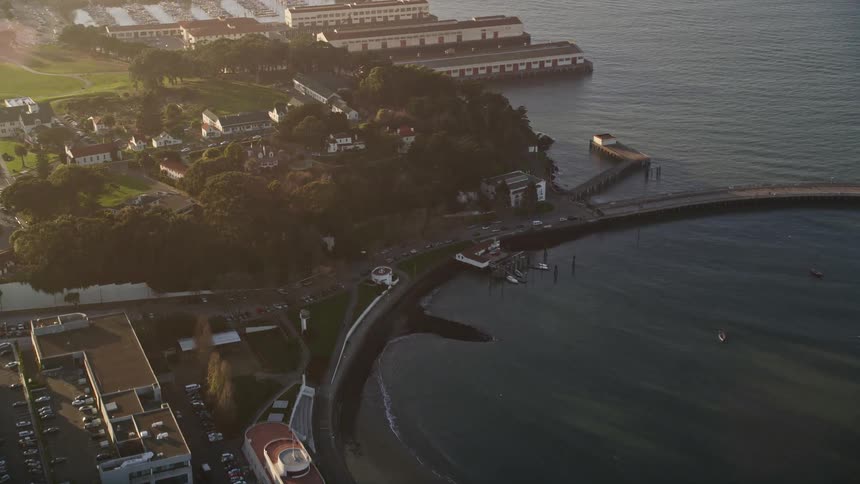 Aerial view of a coastal town with a harbor and green spaces