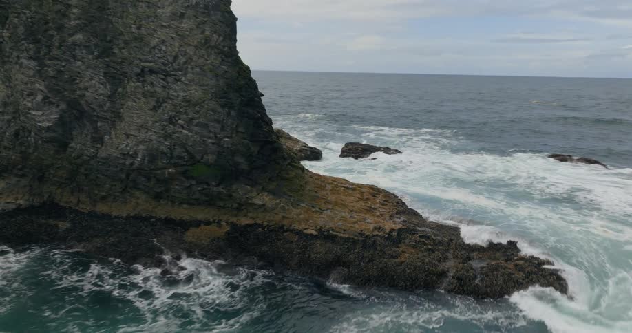 Aerial view of waves crashing against a rocky shoreline