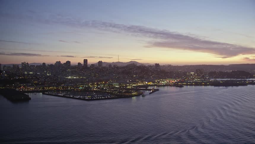 Aerial view of a coastal city at sunset