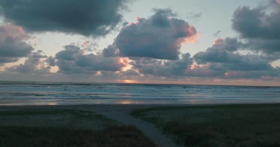 Low waves lapping the beach at sunrise