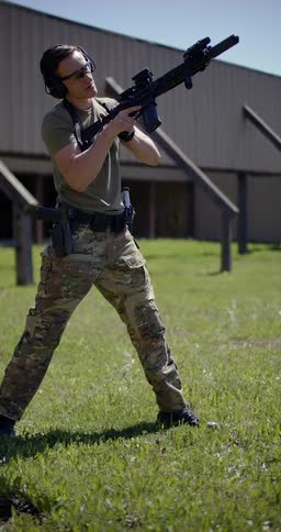 A soldier is firing a rifle