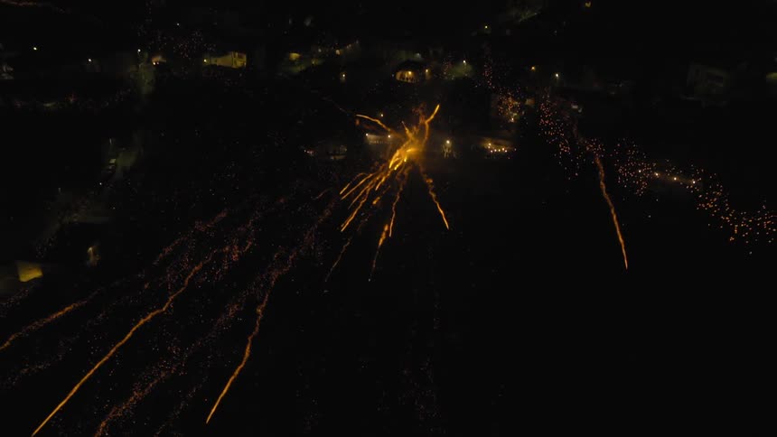 Many fireworks streaking across the sky simultaneously