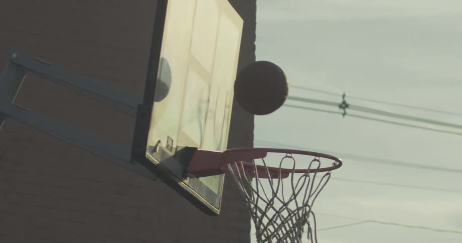 A basketball bounces on a hoop and fails to drop through the net