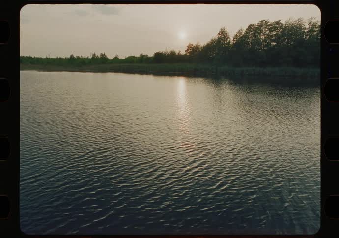 Water in a lake ripples with the sun low in the sky