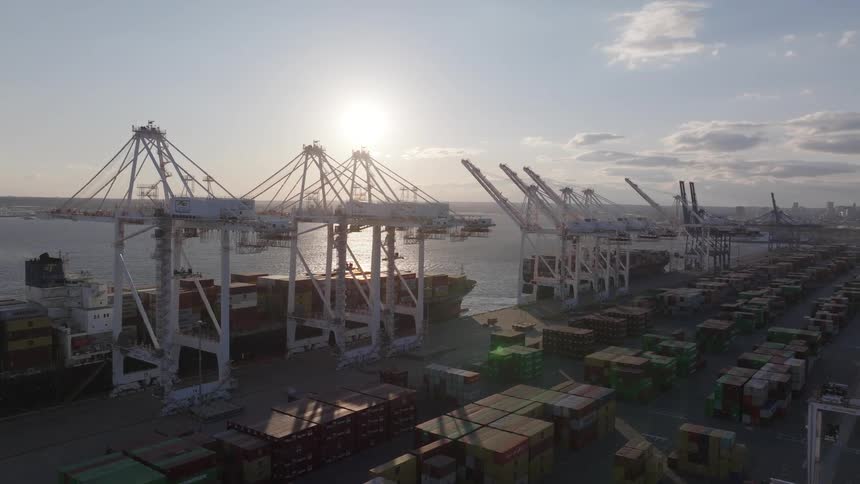 A harbor full of cargo containers and cranes to move them