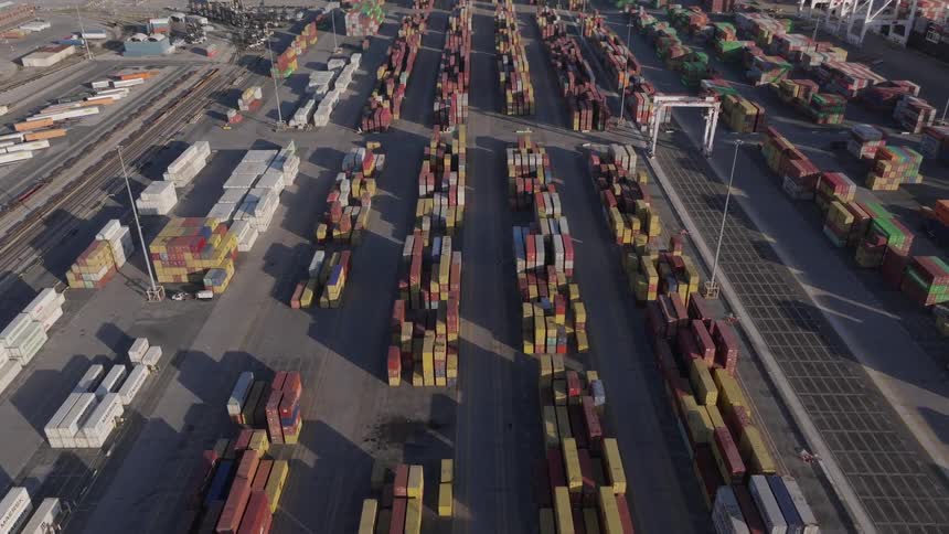 Shipping containers stacked in rows at a port
