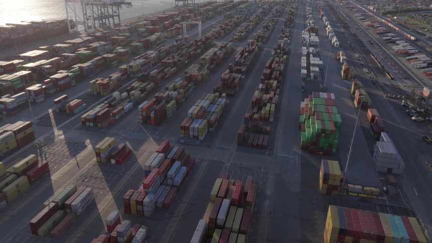 A port with several containers stacked in equal lines