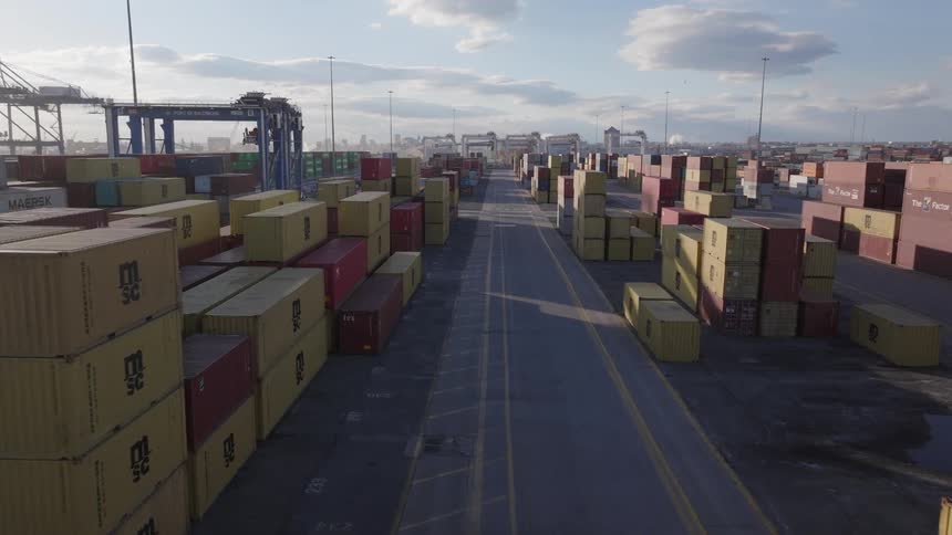Aerial view of stacked shipping containers in a container yard