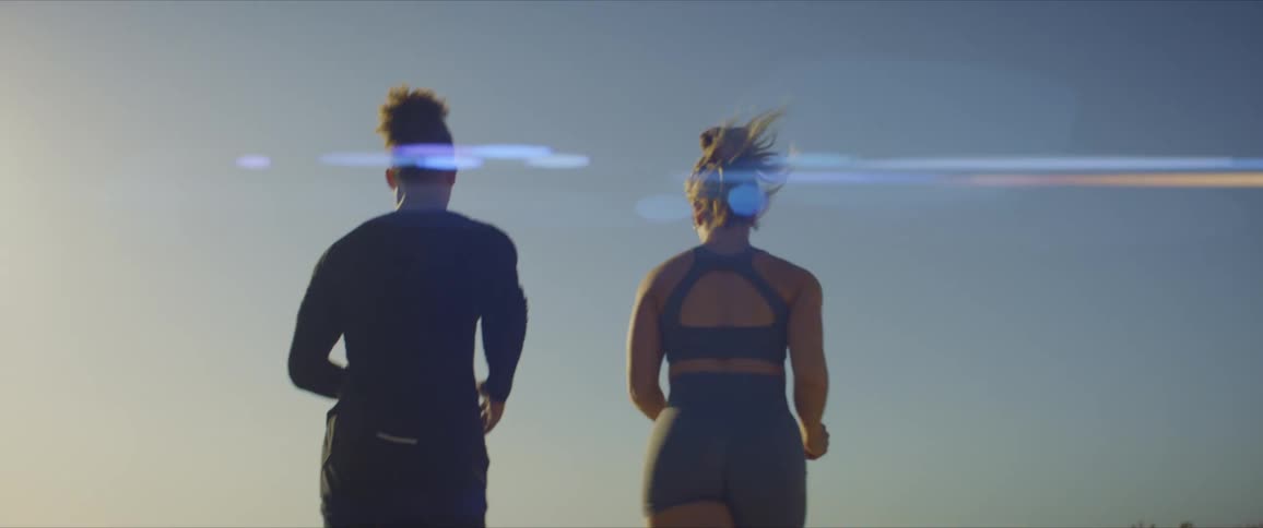 Two joggers run together on a sunny day