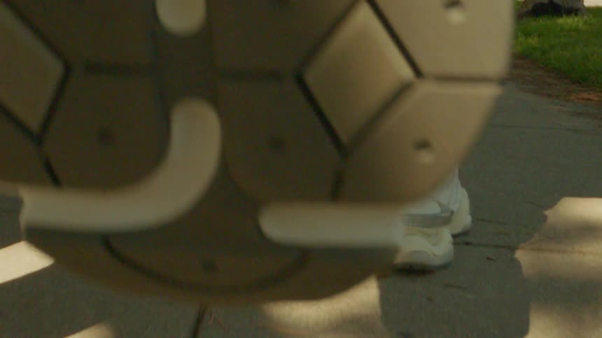 Close up of white sneakers jogging on the sidewalk