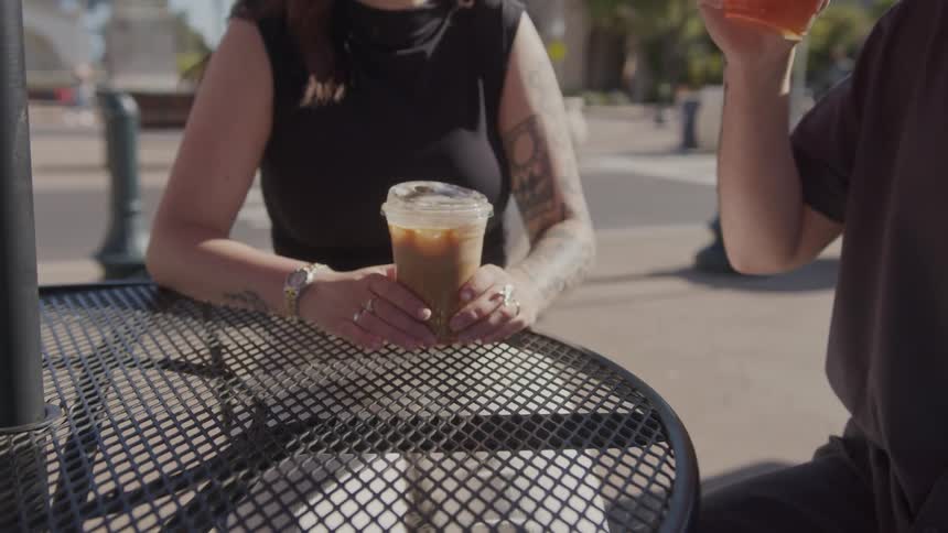 A clip of a couple having a drink outdoor