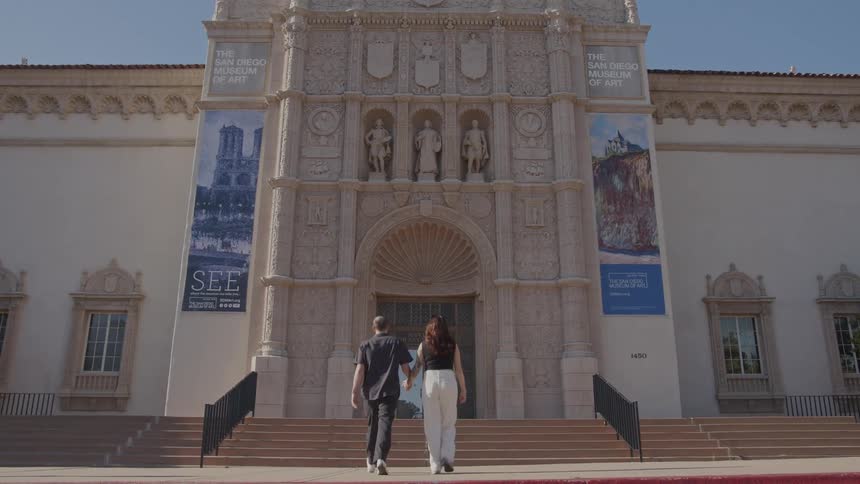 A back clip of a male and female visiting a monument