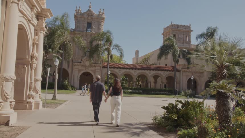 A couple walk across a college campus