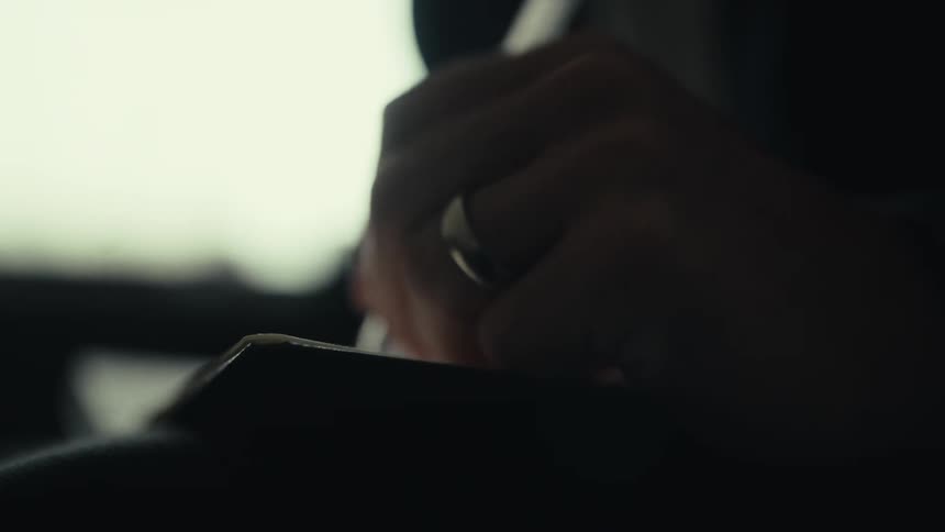 A close of clip of a persons hand hold a pen