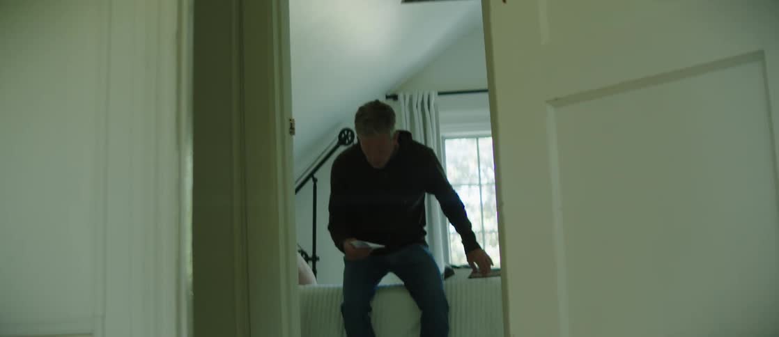 A clip of a man reading a note in the room