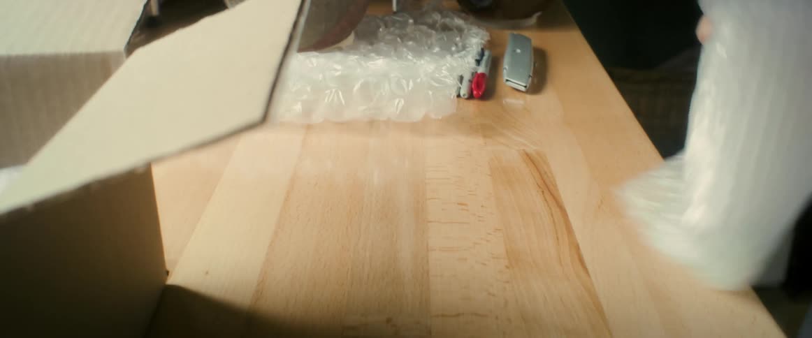 Womans hand putting bubble wrap inside a box