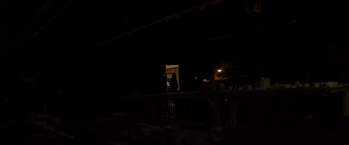 Woman turning off the lights in a vase factory