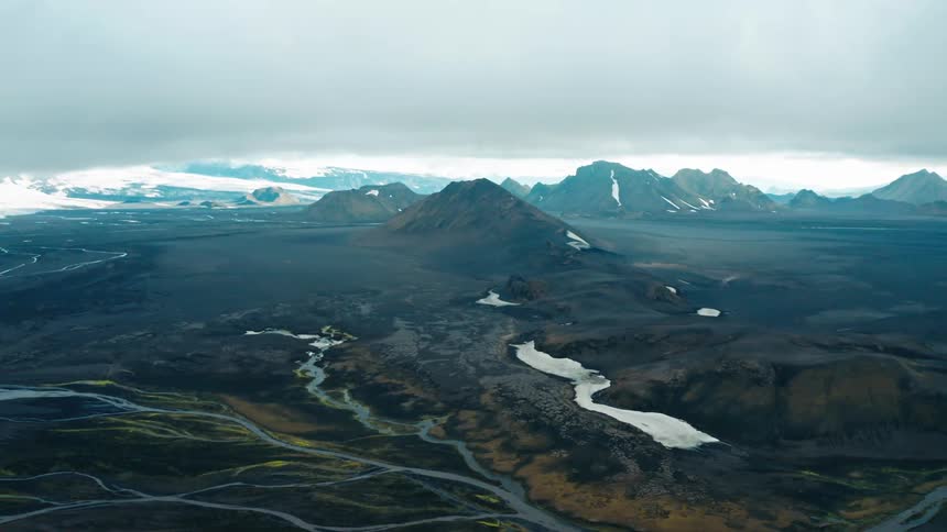 Aerial view of a rugged landscape with meandering rivers