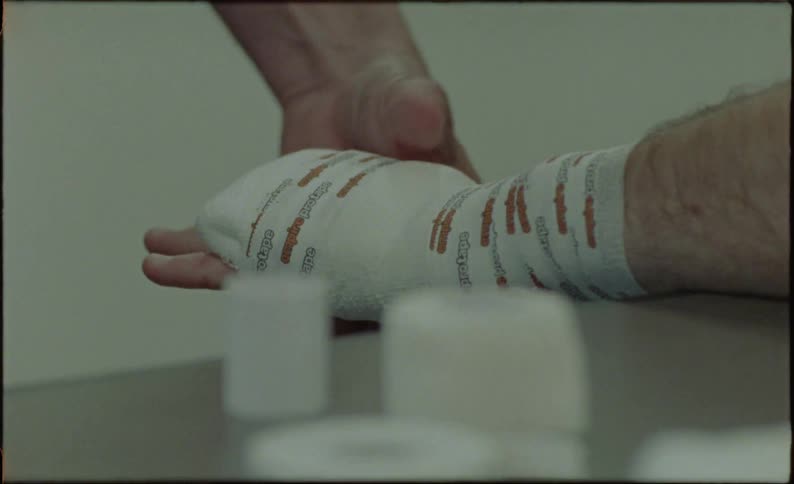 Belt being passed over the hand of a boxer with a white glove