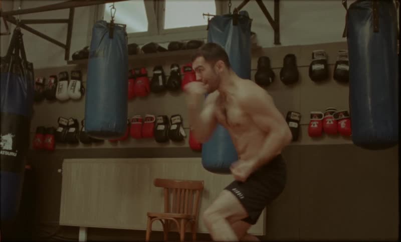 A man is shadowboxing in the gym