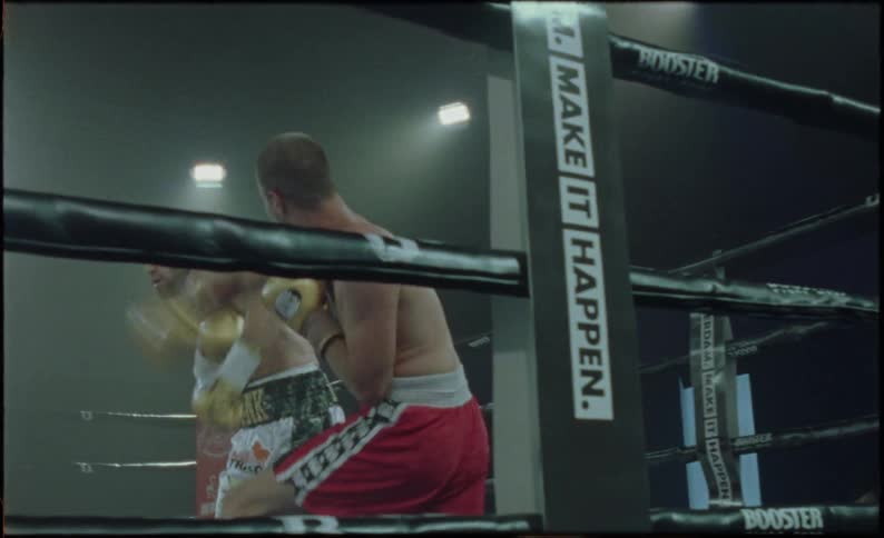 Two boxers in a ring engaged in a match