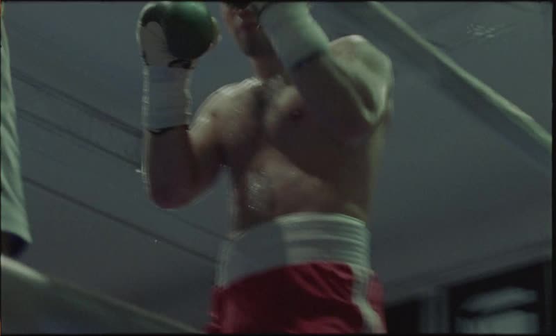 Two boxers battle in a boxing ring