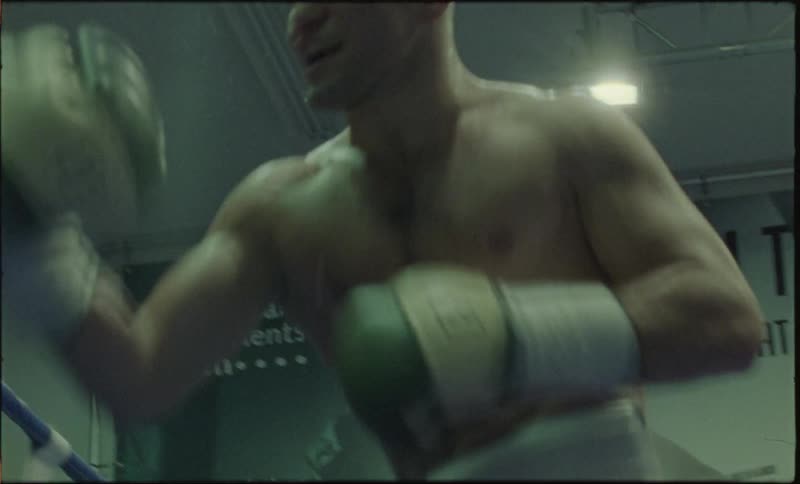 Boxers in a ring with gloves fighting aggressively