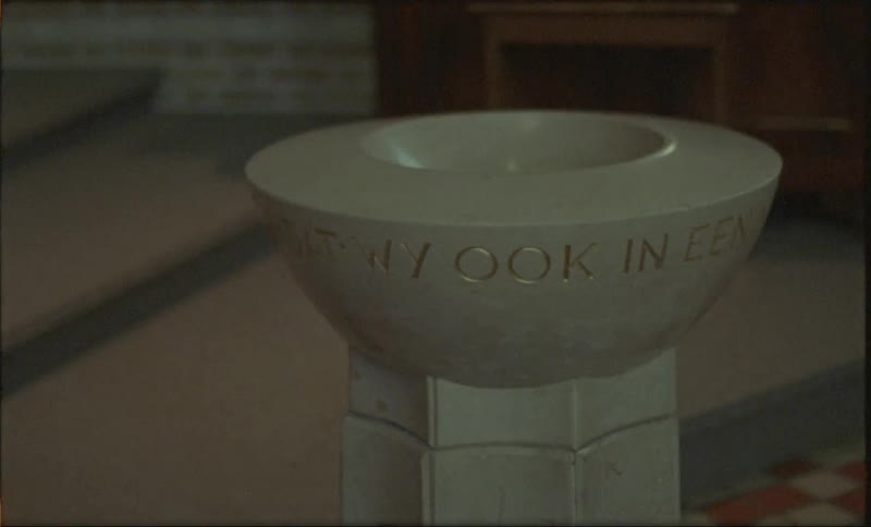 A stand for holy water is in the church