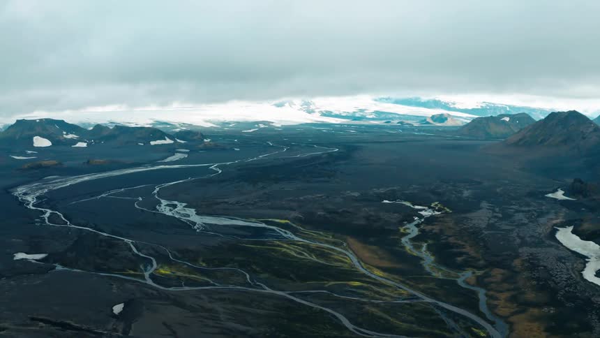 Aerial view of icelandic landscape with snowcapped mountains glaciers and winding rivers