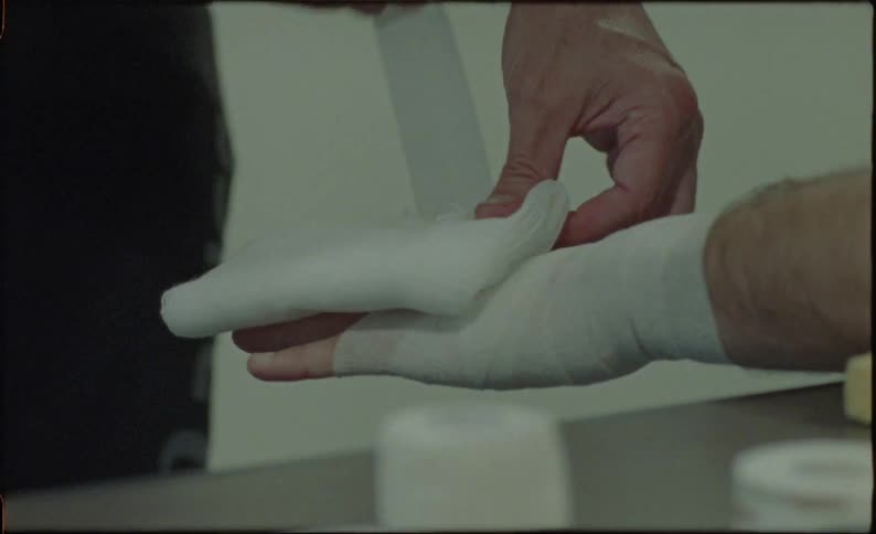 A boxer getting his hands taped for protection