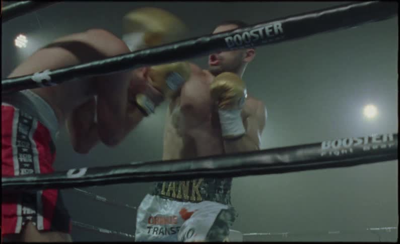 Boxers in a ring fighting aggressively