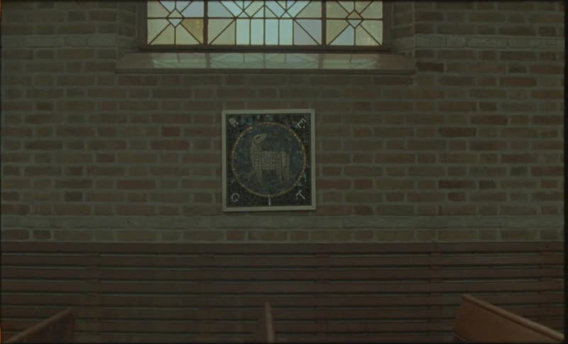 A plaque hangs on a wall in a church