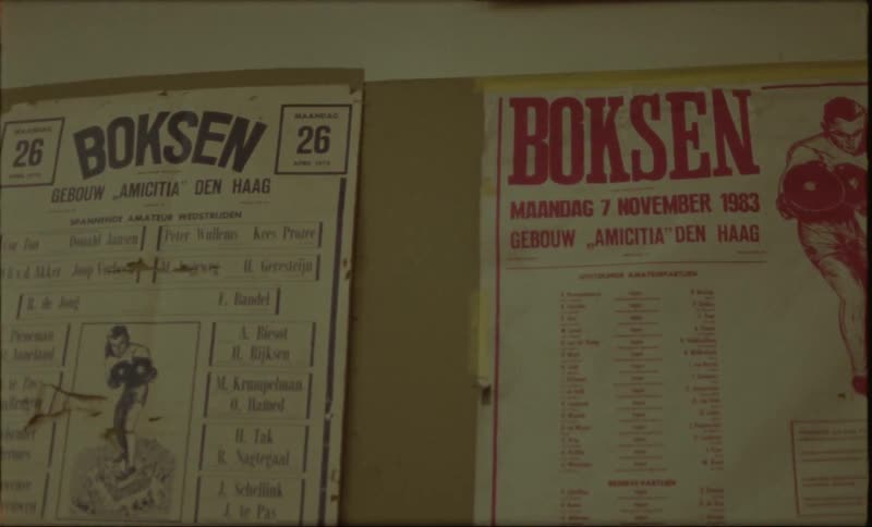 Two vintage boxing event posters pinned to a wall