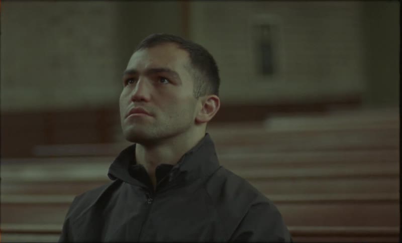 Man sitting on a church coming into focus