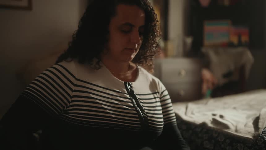 Independent disabled woman gets out of bed and sits in a wheelchair