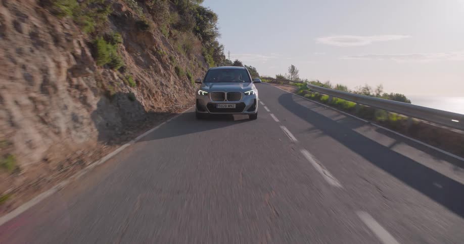 A wide clip of a car traveling