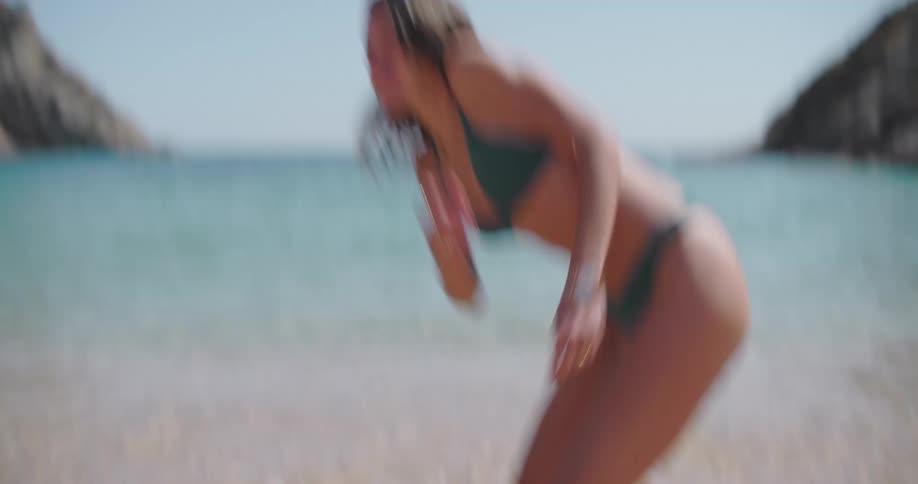 Couple on the beach playing splashing water on each other on a summer day