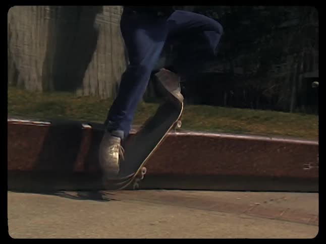 A skateboarder performing a trick on a sidewalk