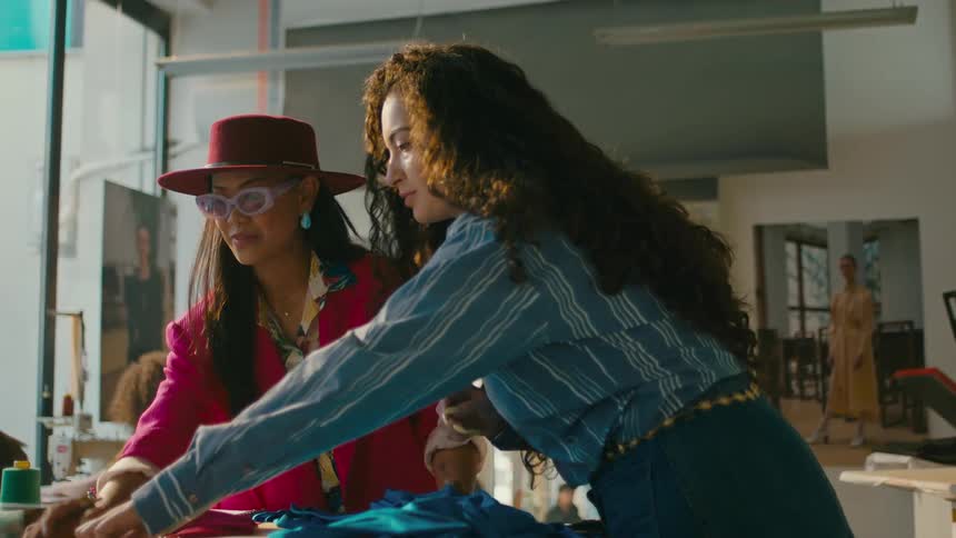 A fashion designer selecting different fabrics in her workshop
