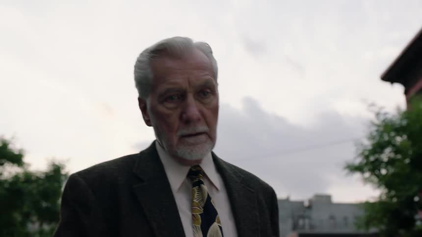 Well-dressed elderly gentleman outdoors on a cloudy day