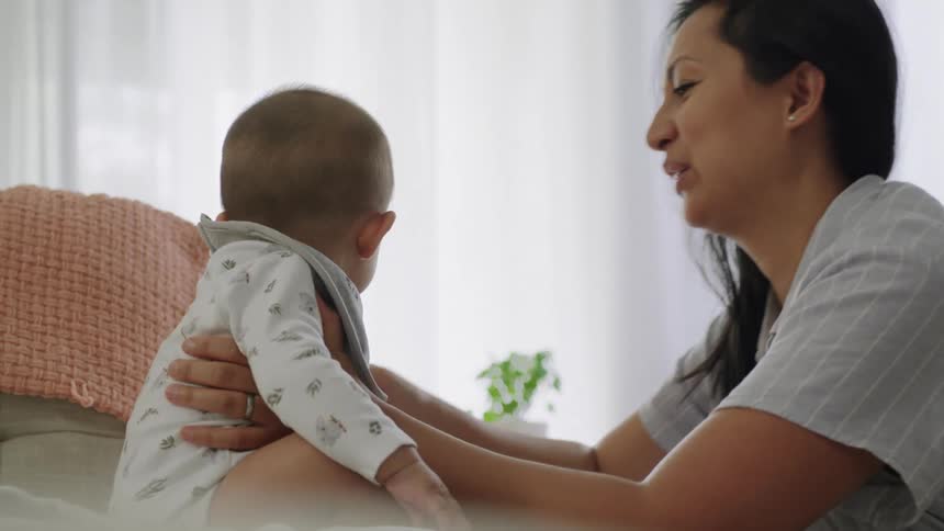 A mother dotes on her infant child